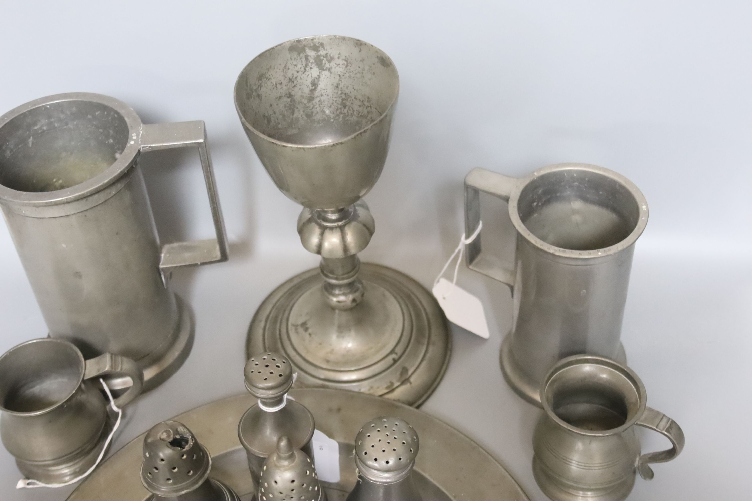 Seven pewter salt or pepper pots, a goblet, 23.5cm, four measures and a plate